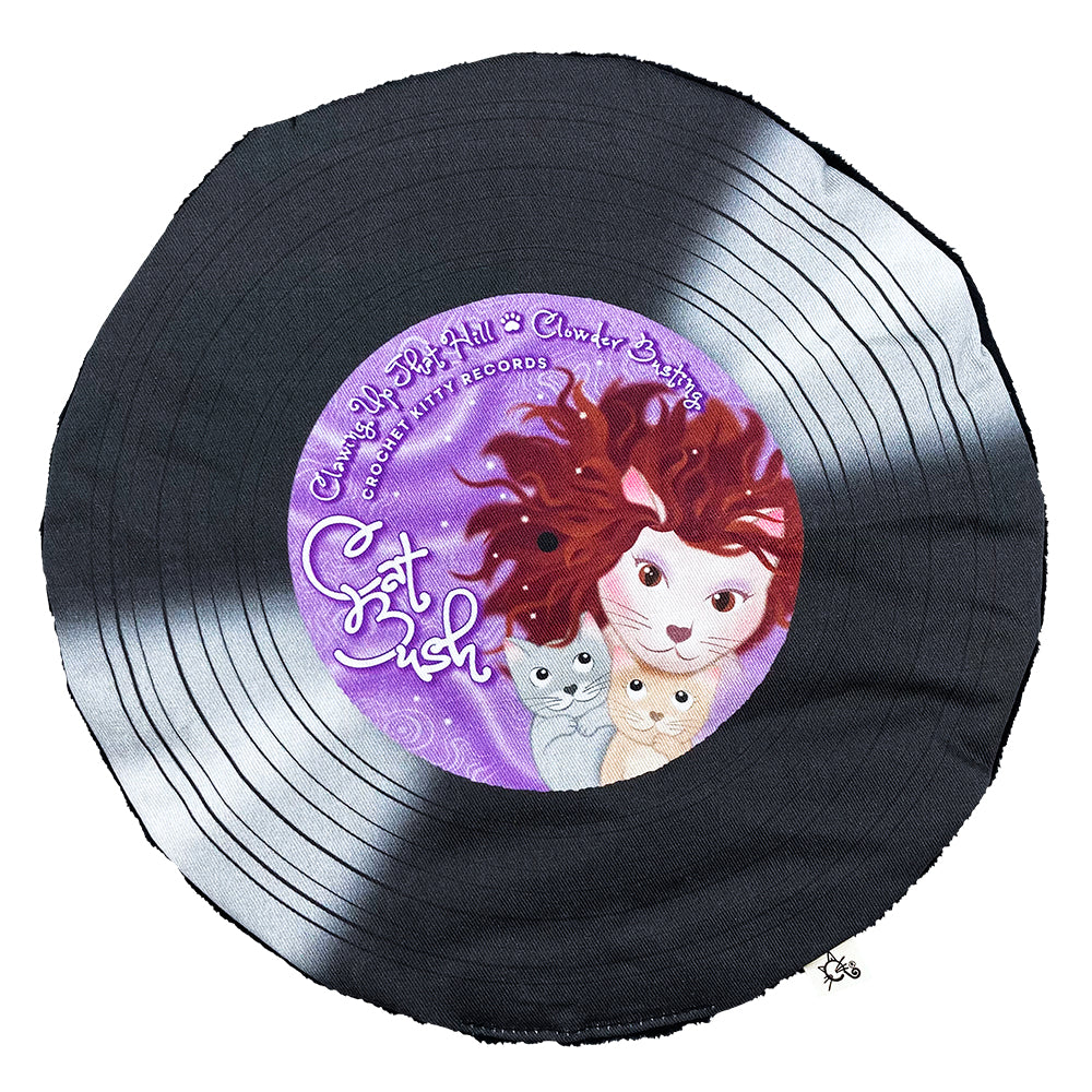 Cat Bush record-shaped catnip cat toy with black printed grooves and a purple label featuring a red brownish haired cat and two kittens.