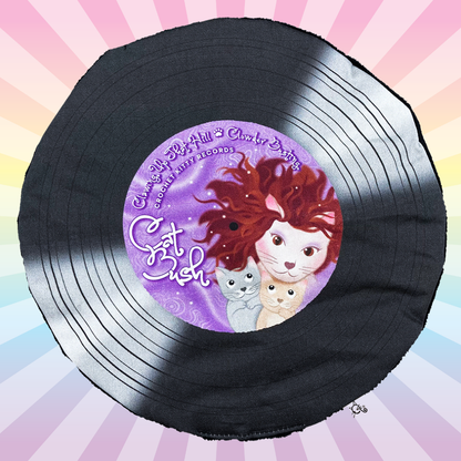 Black Cat Bush catnip record mat with a purple cat illustration label on a pastel rainbow sunburst background.