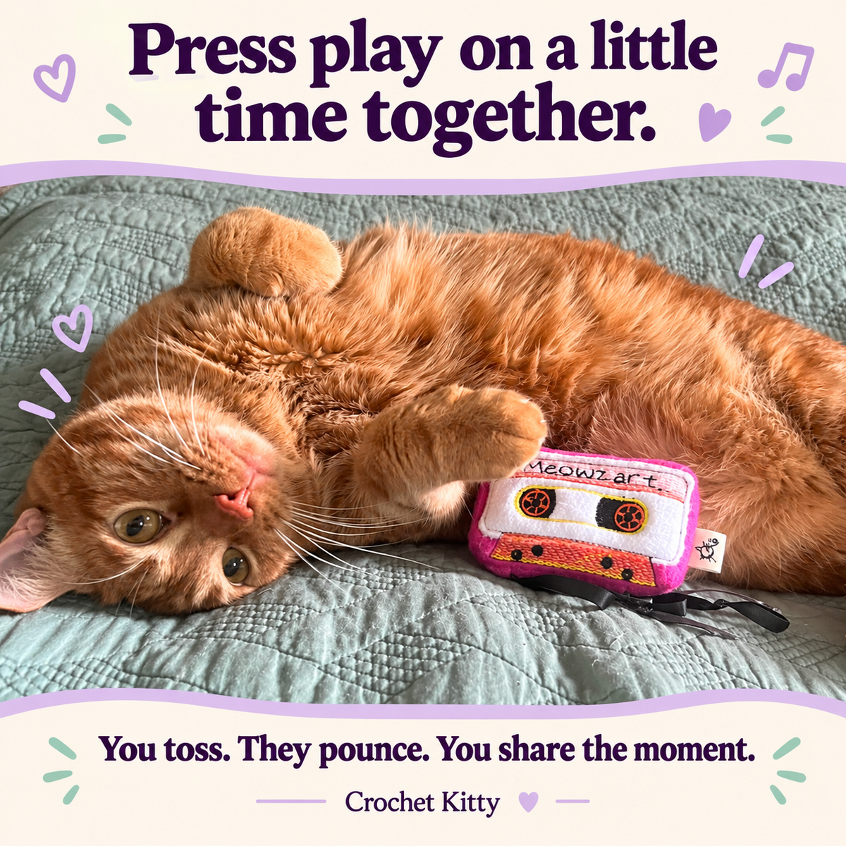 Orange tabby holding Crochet Kitty’s Meowzart cassette catnip toy on a teal quilt. Text: “Press play on a little time together. You toss. They pounce. You share the moment.”