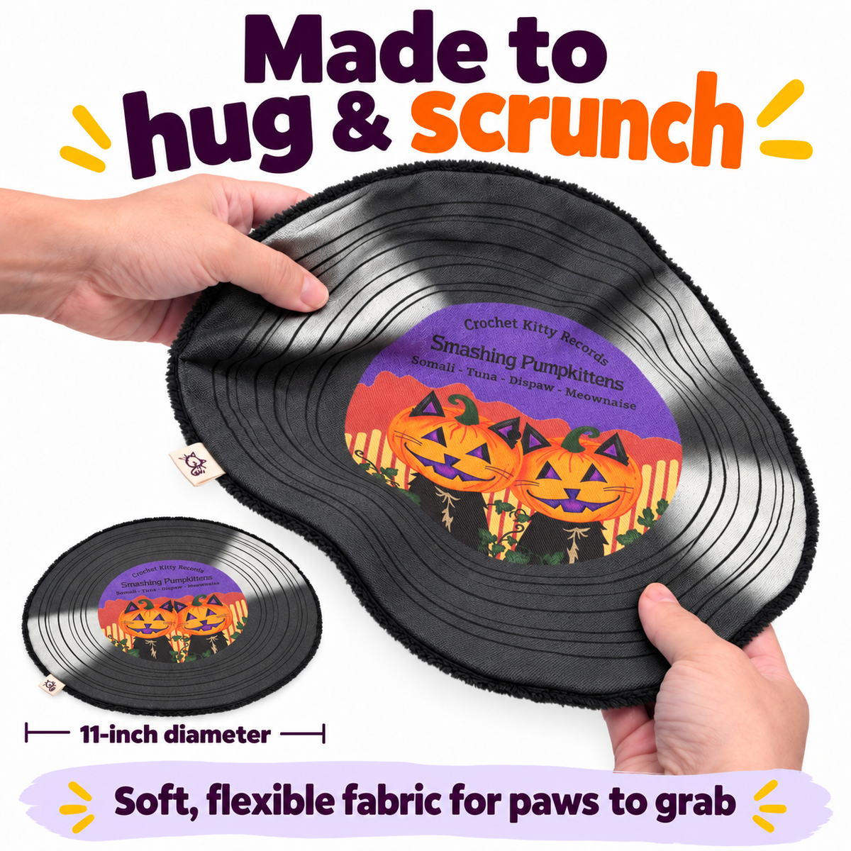 A plush record-shaped cushion being held by two hands. The mat has a black vinyl-record design with a colorful Halloween graphic in the center reading 'Smashing Pumpkins'.